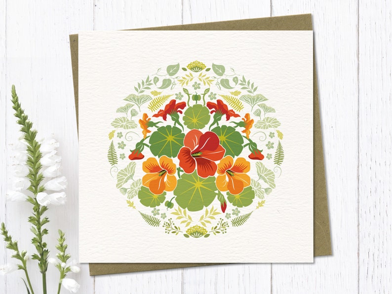 Circular folk art style illustration of orange nasturtium flowers surrounded by decorative botanical elements. My designs are inspired by nordic folk art and bright colours.
Square Greeting Card with brown eco envelope.