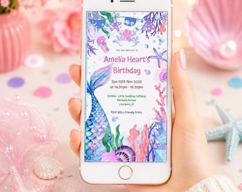 May include: A smartphone displaying a digital birthday invitation with a mermaid theme. The invitation features watercolor illustrations of a mermaid tail, coral, and seashells, with text reading Amelia Heart's Birthday, Sun 13th Nov 2026, at 14.30pm - 16.30pm, Dobbies - Little Seedlings Softplay, Mermaid Avenue, Liverpool L37, and RSVP @Eco Friendly Prints.