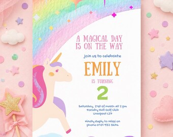 May include: A rectangular birthday invitation card featuring a unicorn with a pink mane and a rainbow background. The text reads: A MAGICAL DAY IS ON THE WAY, join us to celebrate EMILY IS TURNING 2, Saturday, 21st of March at 2 pm, Formby Hall Golf Club, Liverpool L37, Kindly Reply to Nikki on phone 0151 933 5676.