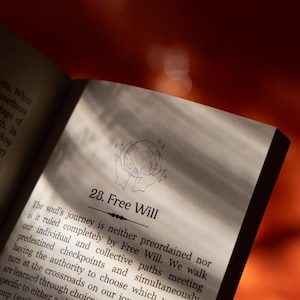 May include: Open book page with the title "28. Free Will". The page features text about the soul's journey and free will, with an illustration of hands holding a globe. The background is a warm, reddish-orange.