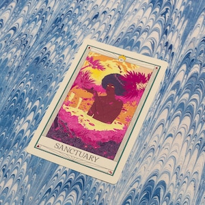 May include: A tarot card with the word "SANCTUARY" at the bottom. The card features a colorful illustration of a person in a tropical setting with pink, orange, and yellow hues. The background is a blue and white marbled pattern.