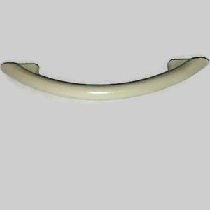 May include: A cream-colored plastic cabinet handle with a curved shape.