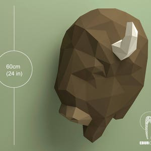 May include: A brown papercraft bison head sculpture with a white paper horn. The sculpture is 24 inches tall.