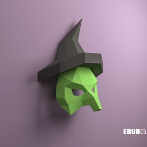 Pode incluir: Uma máscara de bruxa verde com um chapéu preto pontudo. A máscara é feita de papel e tem um efeito 3D.