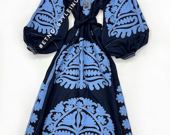 May include: A navy blue embroidered dress with a light blue floral pattern. The dress has a long sleeve and a tie at the waist. #ETNOSTYLEINUA
