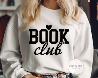 Könnte beinhalten: Weißer Pullover mit schwarzem Text, der "BOOK club" lautet, mit einem kleinen Herzen über dem Wort "BOOK".