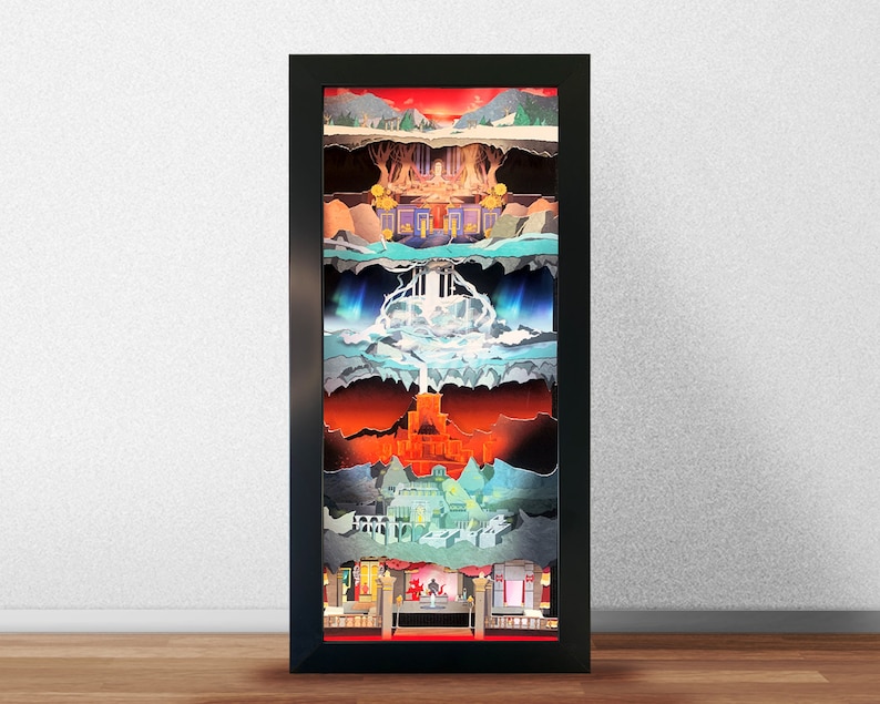 May include: A framed collage of layered paper cutouts depicting a fantasy landscape with mountains, a waterfall, a castle, and a sky with clouds. The artwork is framed in black and has a red mat.
