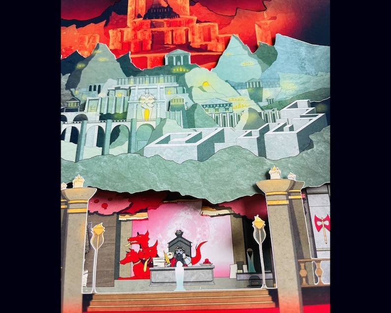 May include: A papercraft diorama depicting a fantasy city with red, green, and gray buildings. The city is surrounded by a red and green forest. Three red dragons are in the foreground, with one dragon wearing a crown.