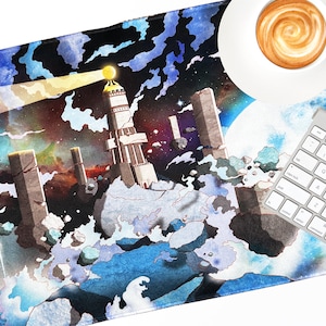 May include: A black and blue mouse pad with a watercolor design of a lighthouse, clouds, and stars. A white keyboard and a white saucer with a cup of coffee are on the mouse pad.