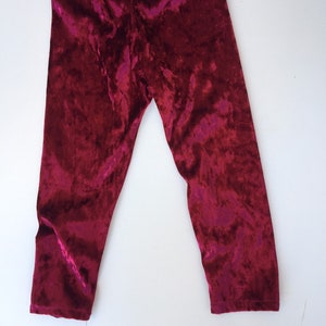 May include: Burgundy velvet leggings with a soft, textured finish.