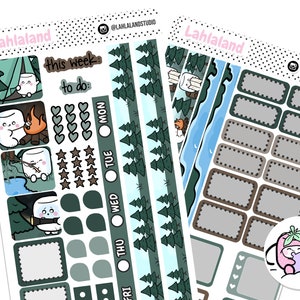 May include: Two sheets of camping-themed planner stickers. One sheet features marshmallow characters, a campfire, and the text "this week to do". The other sheet has rectangular labels and a small strawberry character.