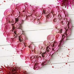 Heart shaped wreath covered in book page roses. This version is done in fuchsia ombre