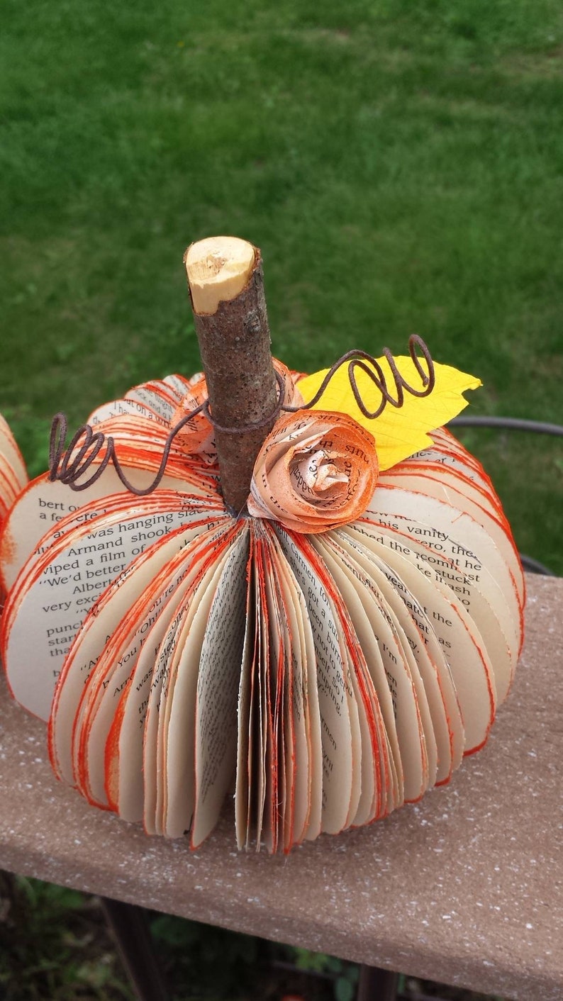 Book page Pumpkin with orange flower and yellow leaf embellishments and brown wire vine