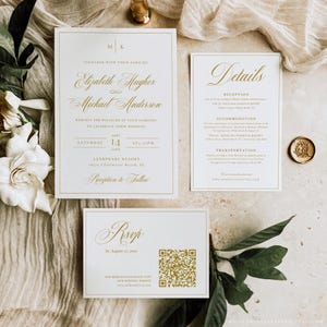 May include: Elegant wedding invitation suite with gold script on white cards. The suite includes an invitation, details card, and RSVP card. The invitation features the names Elizabeth Hughes and Michael Anderson, with the date and time of the wedding.
