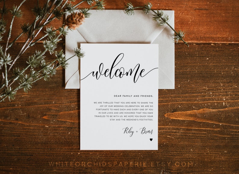 May include: A white card with black text that reads "Welcome" in a cursive font. The text below reads "Dear family and friends. We are thrilled that you are here to share the joy of our wedding celebration. We are so fortunate to have each and everyone of you in our lives and are honored that you have traveled to be with us. We hope you enjoy your stay and the weekend's festivities. Riley + Brian".