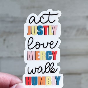 May include: White sticker with the words "act justly love mercy walk humbly" in colorful block letters.