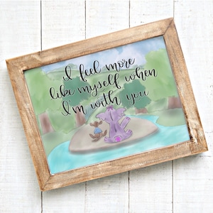 May include: A watercolor illustration of a purple elephant and a brown animal sitting on a small island in a blue river. The text "I feel more like myself when I'm with you" is written in black cursive.