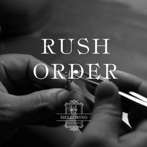 May include: Black and white image of a hand holding a ring with a large gemstone. The text "RUSH ORDER" is above the ring and the logo "HELLORING Fine Jewelry" is below the ring.