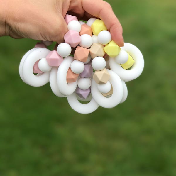 Silicone teether ring lavender , cream yellow , peach , beige , pink