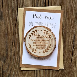May include: A wooden save the date magnet with the text "Save the date" and the names "Daniel & Shauney" with the date "10.08.2018". The magnet is on a white card with the text "Put me on your fridge" and "Formal invitation to follow".