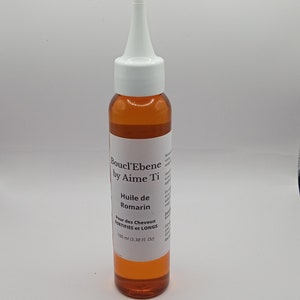 May include: A brown glass bottle with a white dropper top. The bottle is labeled "Boucl'Ebene by Aime Ti Huile de Romarin Pour des Cheveux FORTIFIES et LONGS 100 ml (3.38 FL. Oz)"