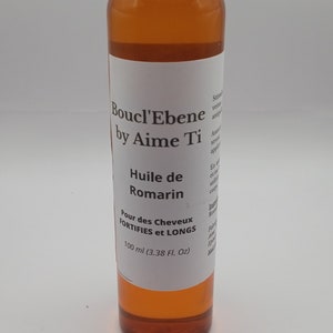 May include: A brown glass bottle with a white label that reads "Boucl'Ebene by Aime Ti" and "Huile de Romarin" for hair that is fortified and long. The bottle contains 100 ml (3.38 fl oz) of product.