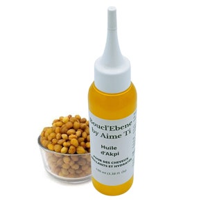 May include: A clear glass bottle with a white cap and a yellow liquid inside. The bottle is labeled "Boucl'Ebene by Aime Ti Huile d'Akpi POUR DES CHEVEUX BRILLANTS ET HYDRATES 100 ml (3.38 fl. oz)".