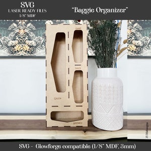 May include: A wooden organizer with cutouts for different sizes of plastic bags, labeled "Gallon", "Sandwich", "Snack", and "Quart". The organizer is made of 1/8 inch MDF and is compatible with Glowforge.