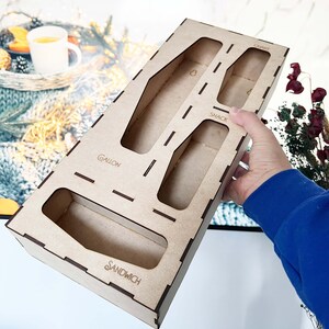 May include: Wooden organizer with compartments labeled "Gallon", "Sandwich", "Snack", and "Quart".