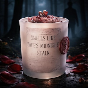May include: A frosted glass candle with the text "Smells Like Zade's Midnight Stalk" and a red wax seal. The candle is filled with dark red petals and is set against a blurred forest background.