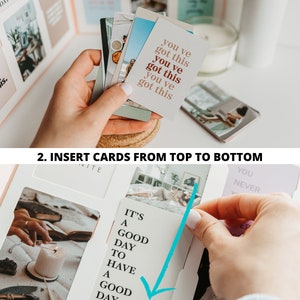 May include: Image showing the steps to assemble a card display. The first step shows a hand holding a stack of cards with the text "you've got this." The second step shows a card being inserted with the text "It's a good day to have a good day."