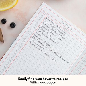 May include: A white recipe book with a red and pink index page. The index page lists recipes with page numbers. The text on the index page reads "INDEX RECIPE" and includes recipes such as "New York Cheesecake", "Tuna Salad Sandwich", "Zucchini Chicken Alfredo", "Chocolate Brownie Cake", "Chicken Curry", "Full English Breakfast", "Pavlova", "Vegetarian Lasagna", "Black Bean and Sweet Potato Quesadillas", "Classic Lasagna", and "One-Pan Teriyaki Chicken Veggie". The text at the bottom of the image reads "Easily find your favorite recipe: With index pages".
