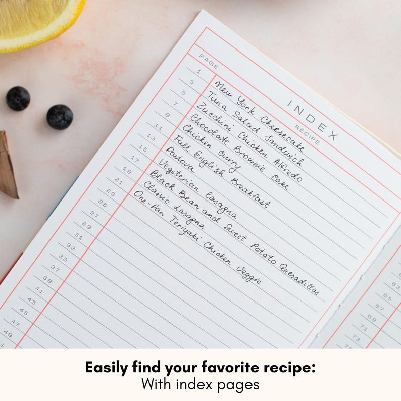 May include: A white recipe book with a red and pink index page. The index page lists recipes with page numbers. The text on the index page reads "INDEX RECIPE" and includes recipes such as "New York Cheesecake", "Tuna Salad Sandwich", "Zucchini Chicken Alfredo", "Chocolate Brownie Cake", "Chicken Curry", "Full English Breakfast", "Pavlova", "Vegetarian Lasagna", "Black Bean and Sweet Potato Quesadillas", "Classic Lasagna", and "One-Pan Teriyaki Chicken Veggie". The text at the bottom of the image reads "Easily find your favorite recipe: With index pages".
