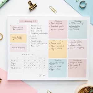 May include: A weekly planner with a habit tracker. The planner is divided into daily sections with a list of tasks for each day. The habit tracker includes a list of habits with checkboxes for each day of the week. The planner is on a white background with a pink, blue, and yellow color scheme.