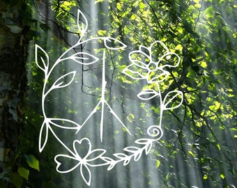 May include: A white peace sign drawn in a circle surrounded by green leaves and flowers. The peace sign is in the center of the image, with sunlight shining through the leaves in the background.