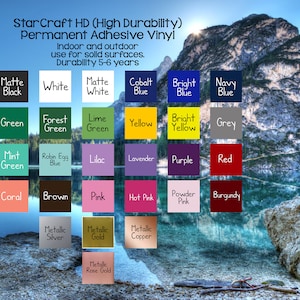 May include: A chart of colour swatches for vinyl decals. The colours include black, white, blue, green, yellow, red, pink, brown, orange, beige, silver, gold, copper, and rose gold. The chart is set against a backdrop of a mountain lake.