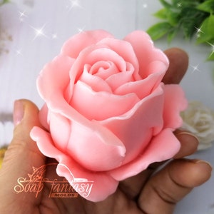 May include: A pink rose soap mold. The mold is made of silicone and is designed to create a realistic rose soap.