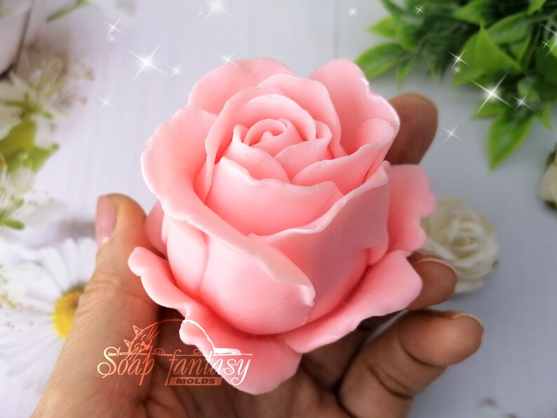 May include: A pink rose soap mold. The mold is made of silicone and is designed to create a realistic rose soap.