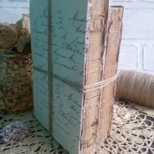 May include: Two antique books bound in brown leather with a handwritten note on the front cover. The books are tied together with twine.
