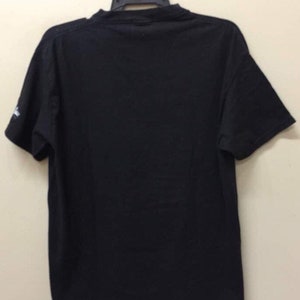 May include: A black short-sleeved t-shirt with a crew neck.