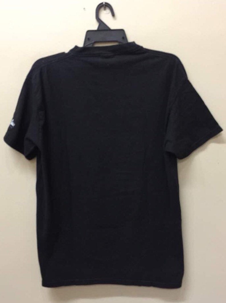 May include: A black short-sleeved t-shirt with a crew neck.