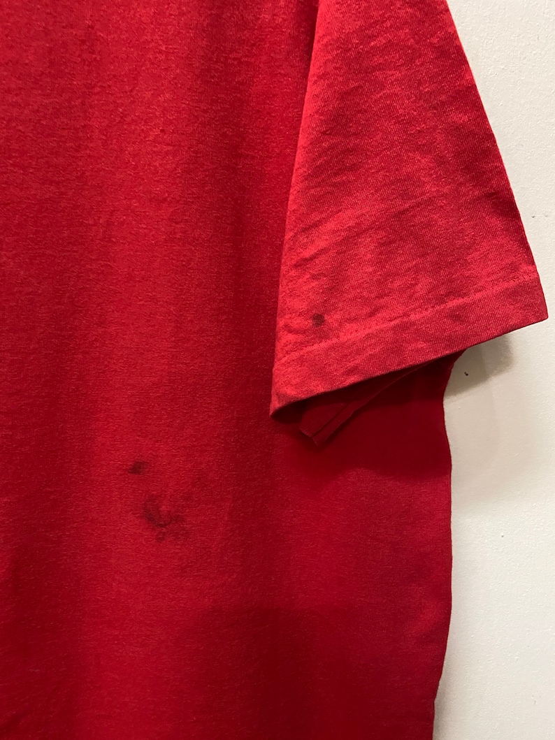 May include: A red t-shirt with a few small stains.