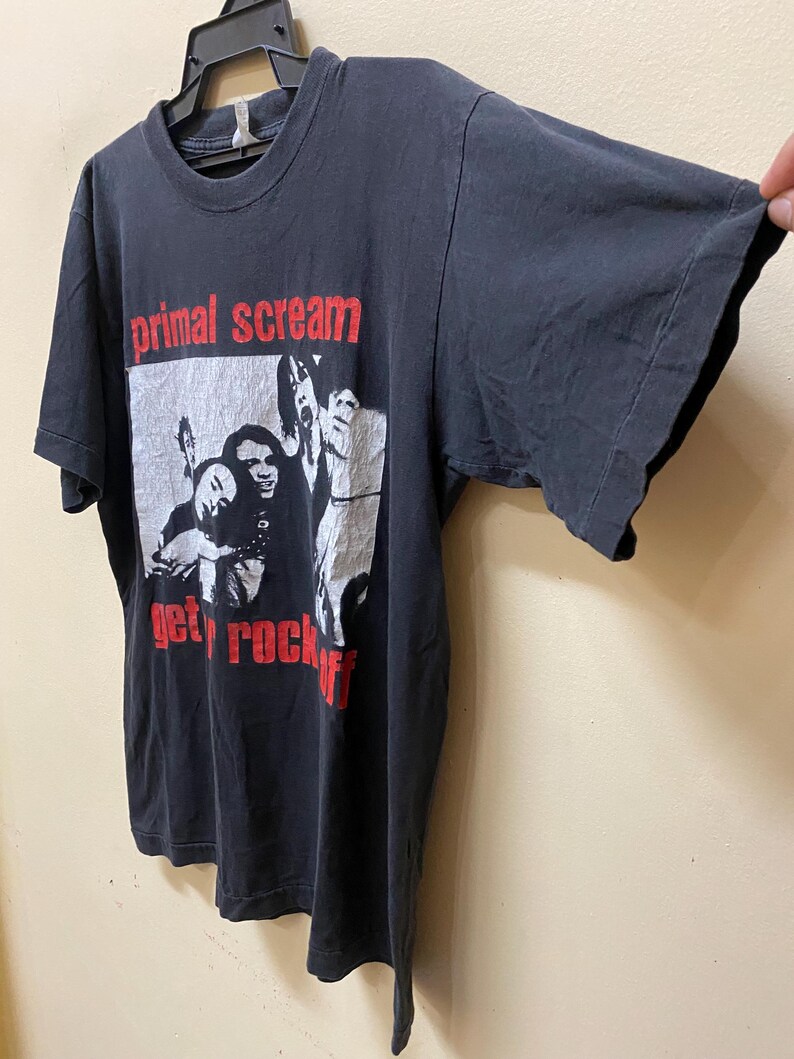 May include: Black t-shirt with a white and red graphic print of a band called "Primal Scream" with the text "Get Rock Off".