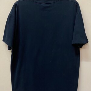 May include: A black short-sleeved t-shirt with a crew neck.