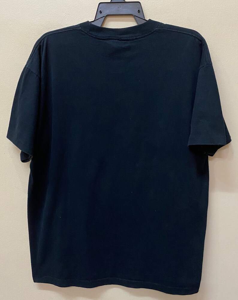 May include: A black short-sleeved t-shirt with a crew neck.