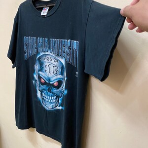 May include: Black t-shirt with a blue and white skull graphic. The skull has red eyes and the text "Stone Cold University Class of 3:16" is printed on the shirt.