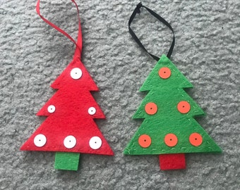 May include: Two felt Christmas tree ornaments, one red with white buttons and one green with orange buttons.