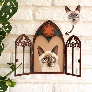 May include: A wooden framed stained glass window with a cat portrait inside. The window is divided into three sections, with the center section featuring a portrait of a Siamese cat with blue eyes. The side sections are empty and have a gothic arch design.
