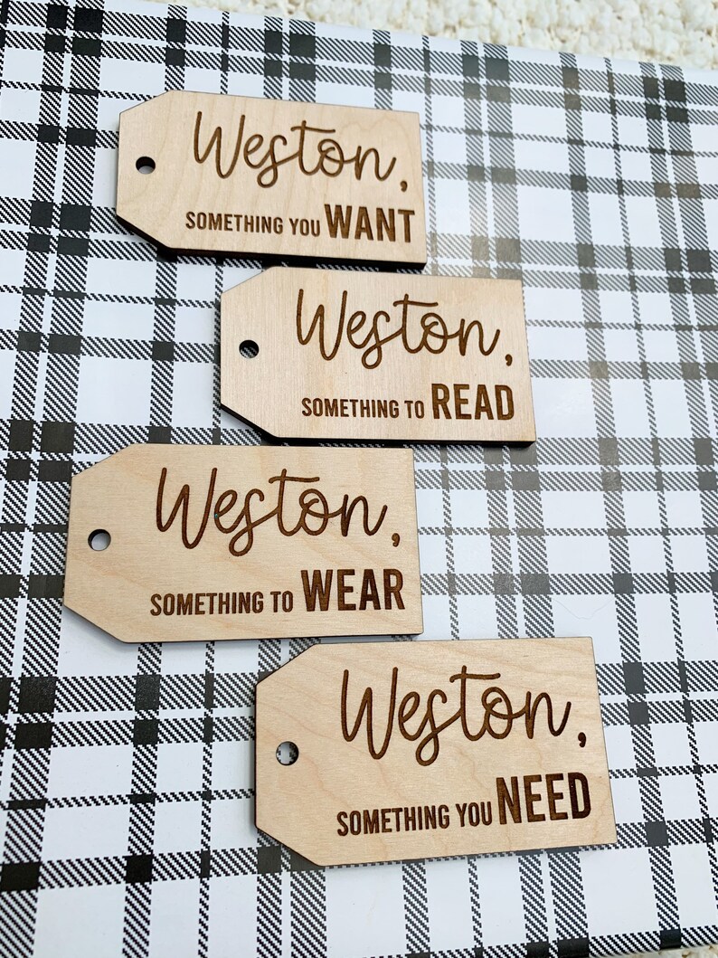 May include: Four wooden gift tags with the name Weston and a category for the gift. The categories are: Something You Want, Something to Read, Something to Wear, and Something You Need.