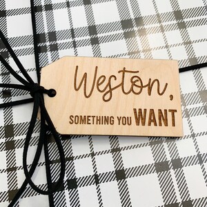May include: A wooden gift tag with the name Weston and the text "Something you WANT" in black lettering.